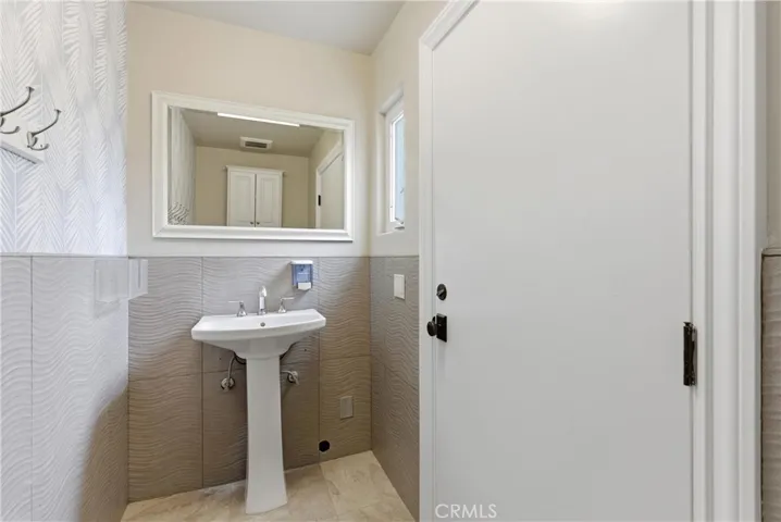Outdoor shower and pool bathroom access from backyard