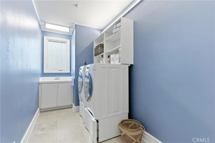 1st floor laundry room with storage cabinets and counter space