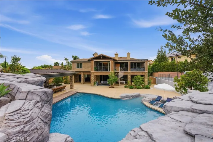 Rock slide and spa overlooking backyard and pool