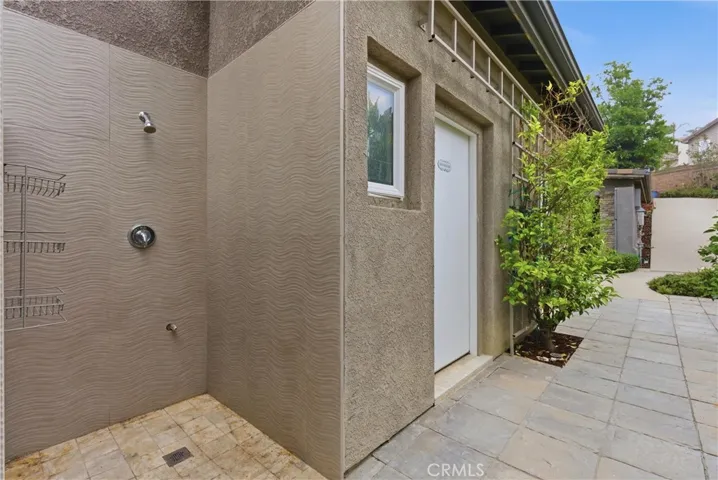 Outdoor shower and pool bathroom access from backyard