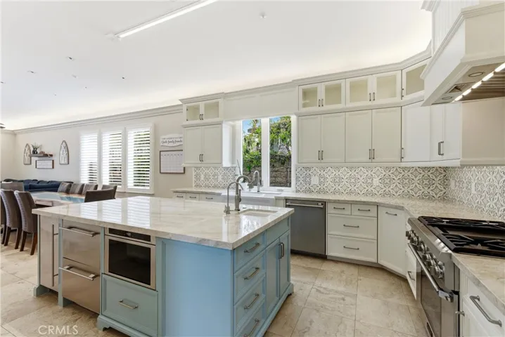 Open concept kitchen and family room with fireplace and island seating