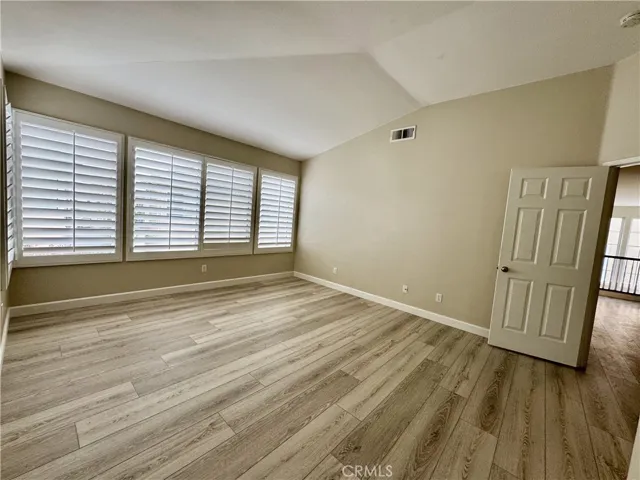 Primary Bedroom has vaulted ceilings and Plantation Shutters