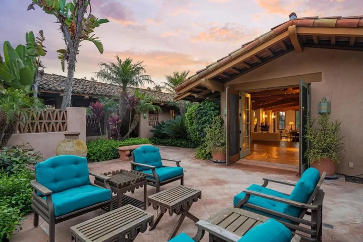 Grand entertaining living room and dining area with adjacent wet bar and outdoor space to enjoy drinks before dinner.
