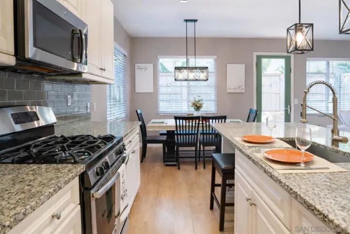 Granite counters, soft close drawers, tons of natural light, open floor plan and a sink in the center island for convenient cooking and prep!