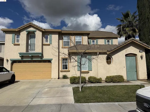 Mediterranean / spanish-style home with stucco siding, a garage, concrete driveway, and a tile roof