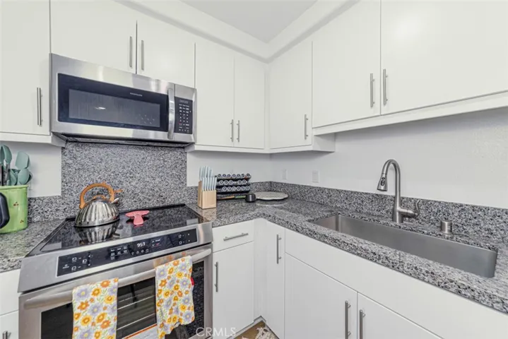 Kitchen with stainless steel farm-style sink.