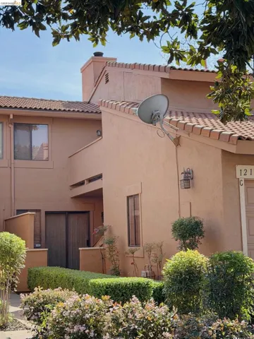 View of property exterior featuring stucco siding and a tile roof