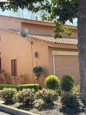 View of side of home with stucco siding and a garage