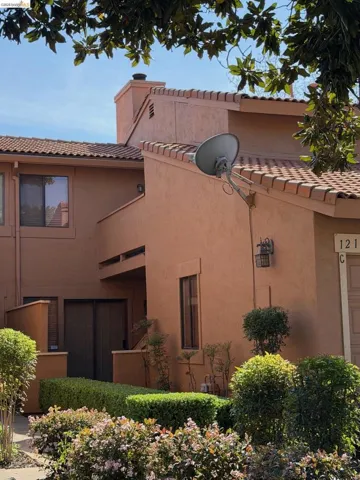 View of home's exterior with stucco siding and a tiled roof