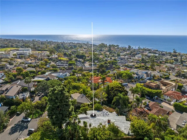 Situated on Virginia Park Drive, a tree-lined, one-way street that loops around a landscaped median, the property enjoys a serene and distinctive setting rarely found in Laguna Village.