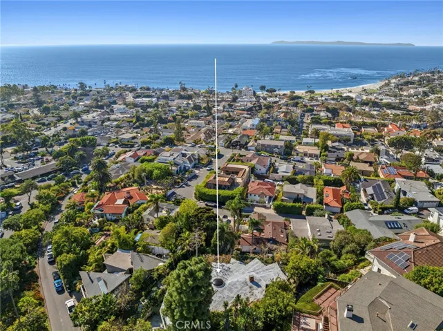 Offering remarkable privacy, the home spans approximately 3,073 square feet with four bedrooms and three baths, and is set on an oversized 11,700-square-foot lot, creating a rare sense of space in this coveted coastal setting.