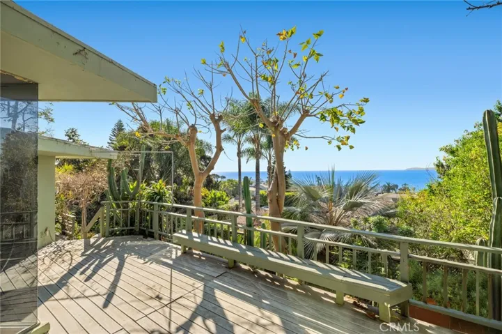 Lush, mature gardens surround the property, enhancing its welcoming presence within this quiet cul-de-sac location, while ocean and sunset views elevate the coastal living experience.
