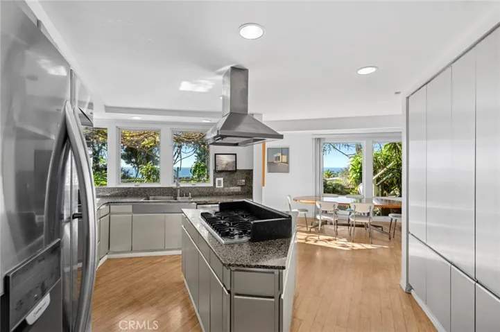 The generous kitchen captures breathtaking ocean and Catalina Island views and flows into the dining area, creating an ideal setting for gatherings.