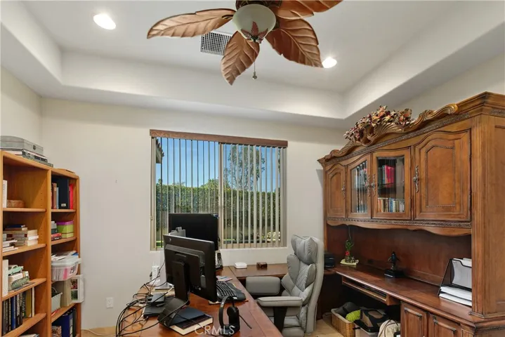 Office with trayed ceiling.