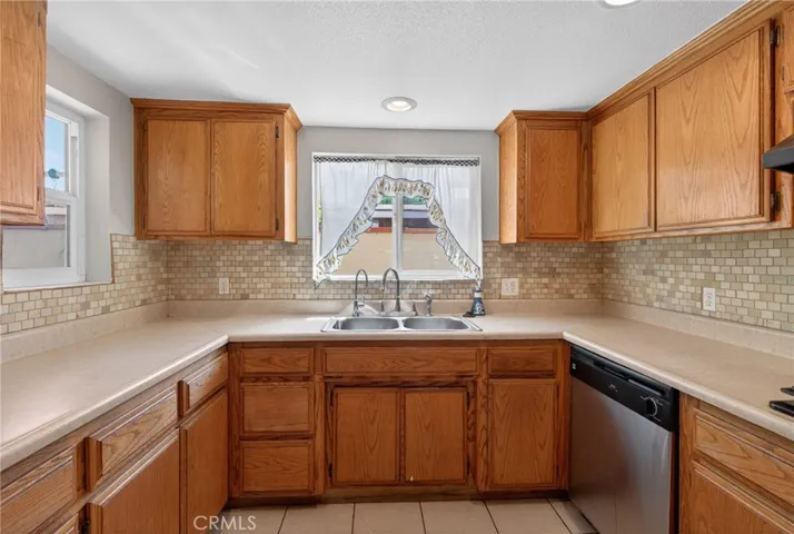 Kitchen view with fairly new cabinets inside laundry room.