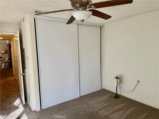 Primary Bedroom Showing Closet Where Washer Dryer is Located.