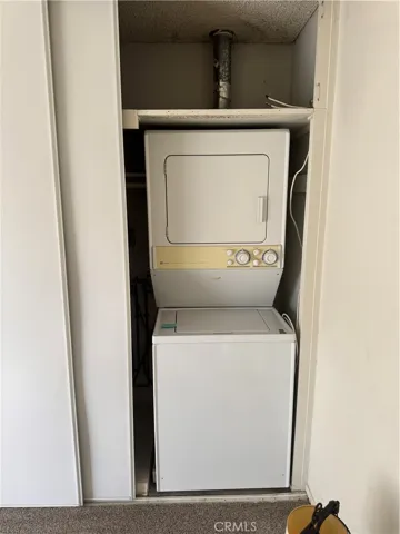 Washer Dryer Located in Primary Bedroom Closet.