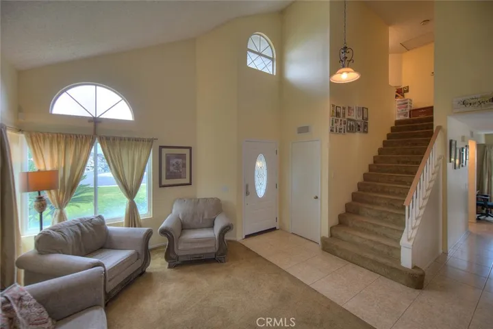 Living room facing front door entrance and stairs to bedrooms