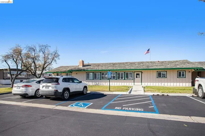 View of property featuring uncovered parking