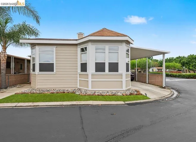 View of property exterior featuring a carport