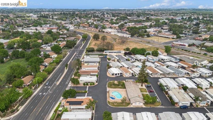 Aerial overview of property's location featuring nearby suburban area