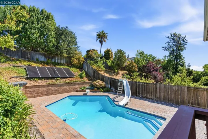 In ground pool with slide and diving board