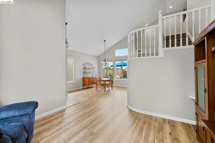 Interior space featuring vaulted ceiling, light wood-type flooring, and a chandelier