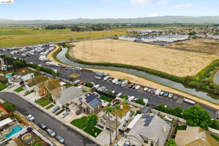 Aerial view of property and surrounding area featuring a mountain backdrop