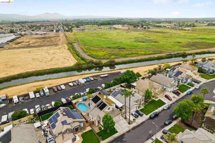Aerial perspective of suburban area featuring a large body of water