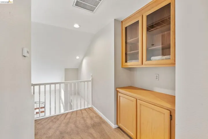 Corridor featuring light carpet, recessed lighting, and vaulted ceiling