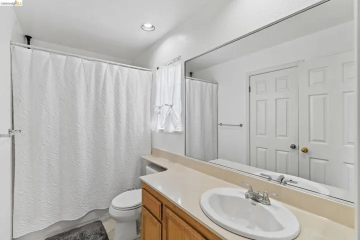 Bathroom with vanity and shower / bath combination with curtain