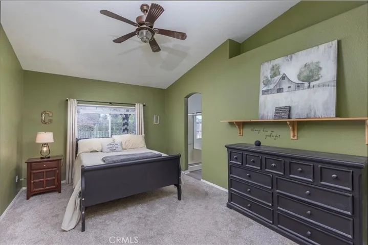 Primary suite with high ceilings.  Arched entry into adjoining bath.