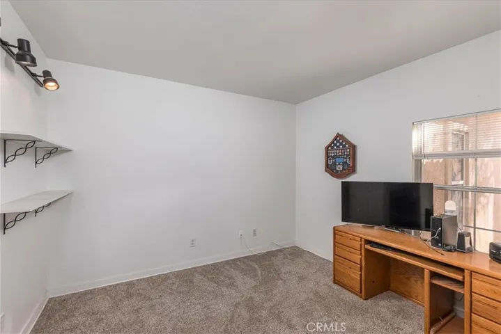 Bedroom at front of home.  Currently used as an office. Newer carpet.