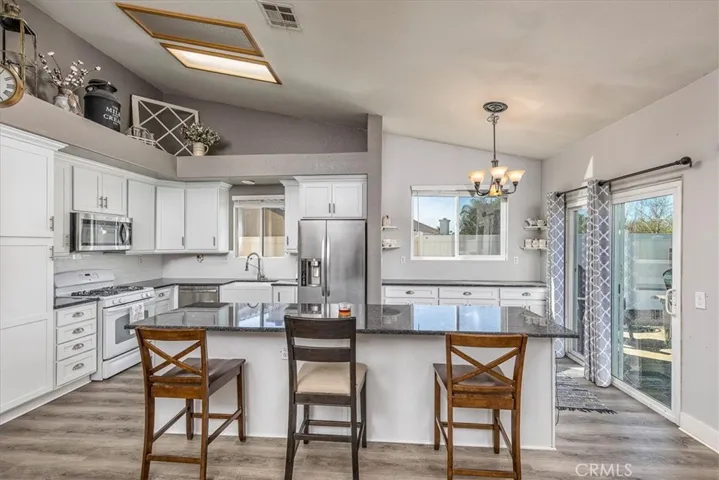 Stunning remodeled kitchen with island. Soft close cabinets Slider to back yard.