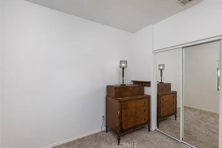 Front bedroom with mirrored closet doors.