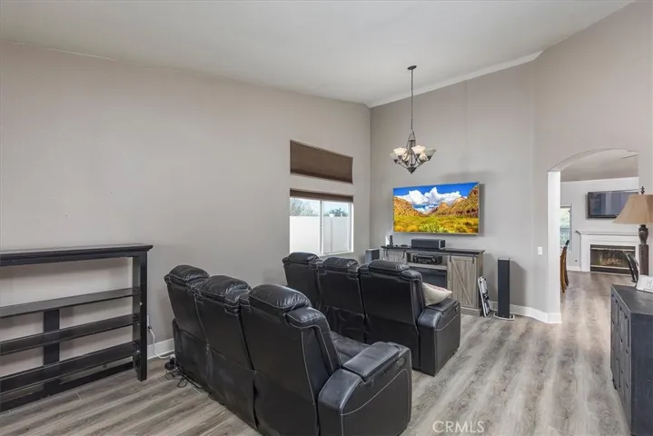 Front room with arched entry into family room and kitchen.