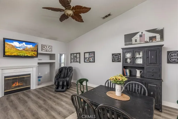 Family room includes hard surface flooring and gas fireplace.