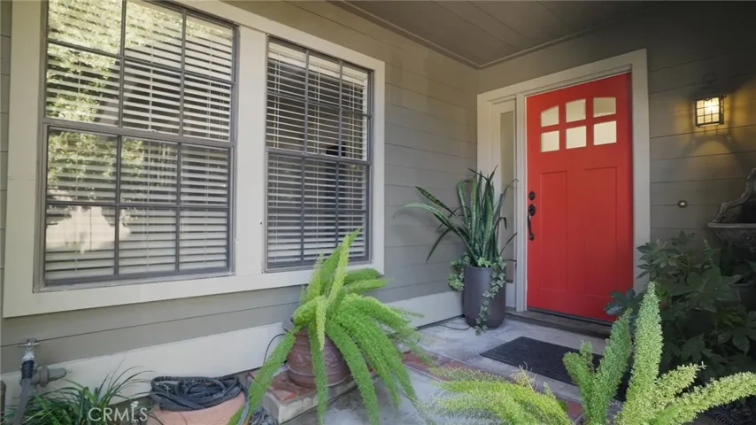 Entry with sharp custom red door and landscaped landing