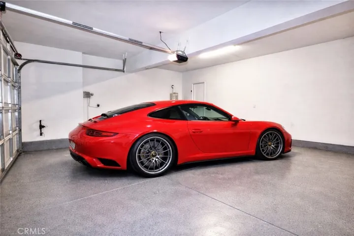 Garage With Pebble Tex Floor, Tankless Water Heater (Virtually Staged)