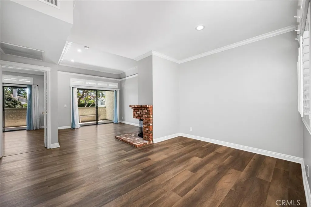 Crown molding, elegant shutters, paneled doors, and recessed lights elevate the design.