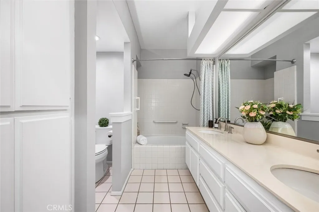 Spacious bathroom with linen closet.