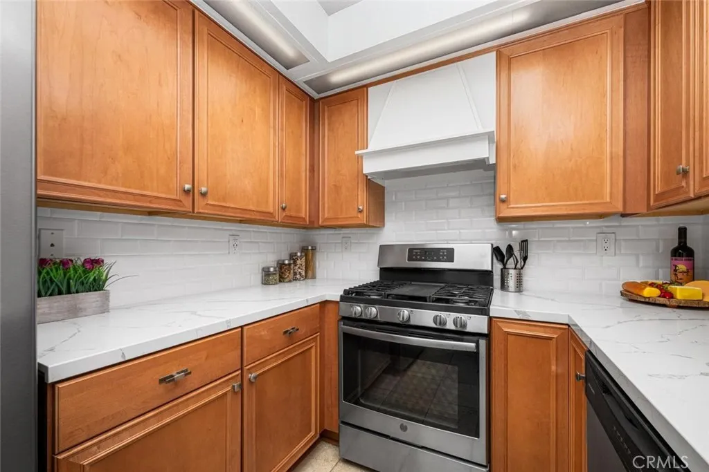 Rich wood kitchen cabinetry provides warmth, depth, and timeless elegance.