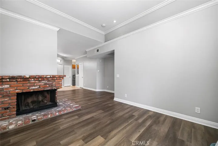 The center of the room features a brick fireplace.