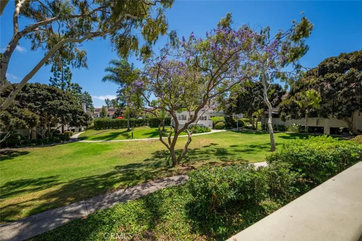 Balcony overlooks a spacious greenbelt.