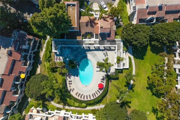 Association Pool and grounds with lush landscaping.