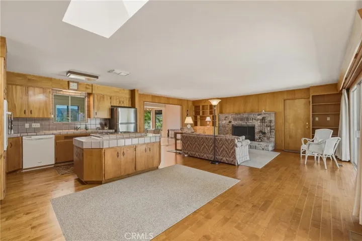 Open floor plan with fireplace in family room, dining room