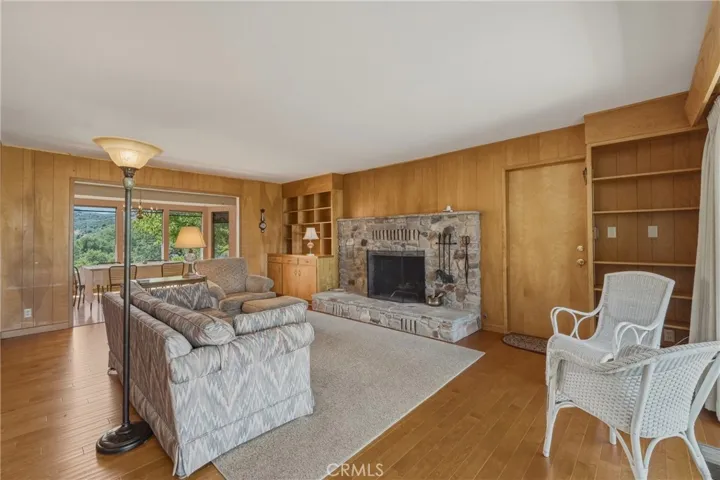 Wood burning fireplace with book shelves. Entry to garage.