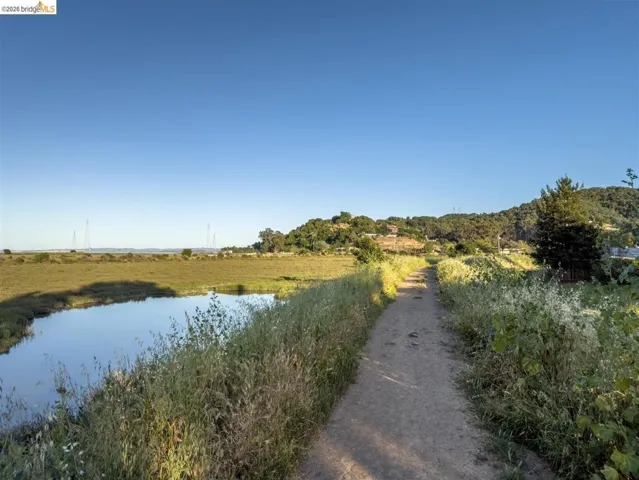 view of road featuring a water view and a rural view