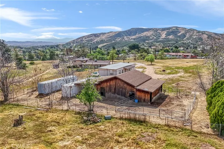 Pipe corral horse enclosure is attached to the barn.