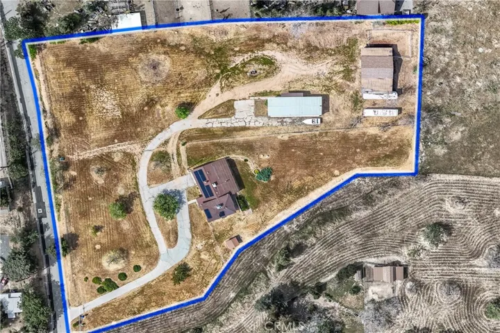 Approximate lot lines of adjoined two parcels.  Main house, manufactured home, and barn visible.
